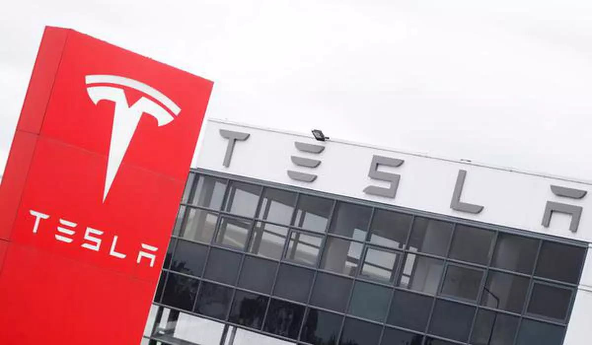 FILE PHOTO: The logo of car manufacturer Tesla is seen at a dealership in London, Britain