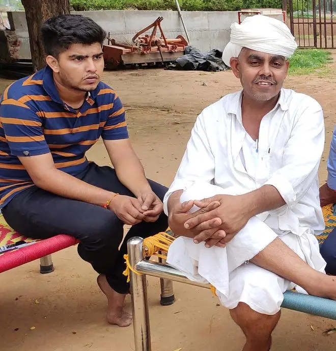 Harjibhai Chaudhary with his son Vipul at his farm in Thavar village of Dhanera taluka of Banaskantha district. Harjibhai Chaudhary with his son Vipul at his farm in Thavar village of Dhanera taluka of Banaskantha district.
