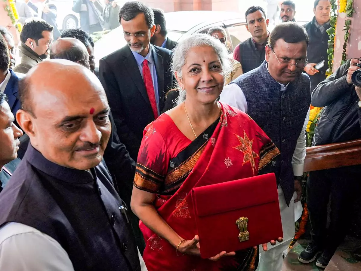 Union Finance Minister Nirmala Sitharaman, flanked by Ministers of State Bhagwat Kishanrao Karad and Pankaj Chaudhary, shows a folder-case containing her Union Budget 2023-24 speech as she arrives at Parliament on Wednesday
