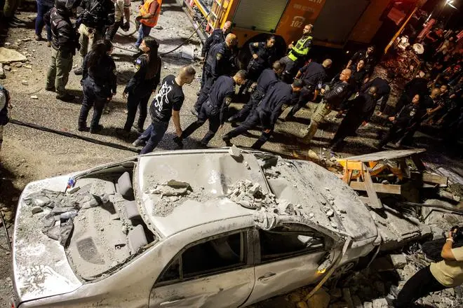 Rescue and security personnel operate after missiles fired from Iran impacted a residential building in northern Israel, in Tamra, Israel, June 15, 2025.