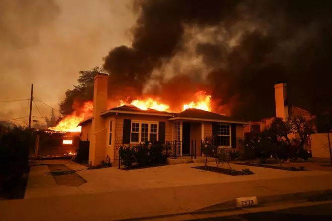 A house burns as powerful winds fueling devastating wildfires in the Los Angeles area force people to evacuate, at the Eaton Fire in Altadena, California, U.S. January 8, 2025. 