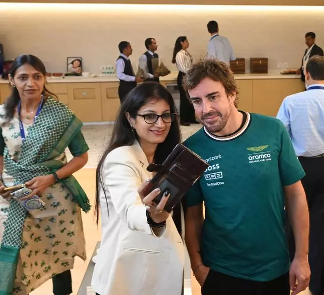 Fernando Alonso, Spanish racing driver for Aston Martin Aramco Formula One (AMF1), poses for selfies with Cognizant staff during a visit to Cognizant’s MEPZ facility in Chennai .
 