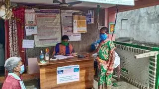 A business correspondent of APGVB helping a bank customer in Borubadra village near Tekkali of Srikakulam district, Andhra Pradesh
