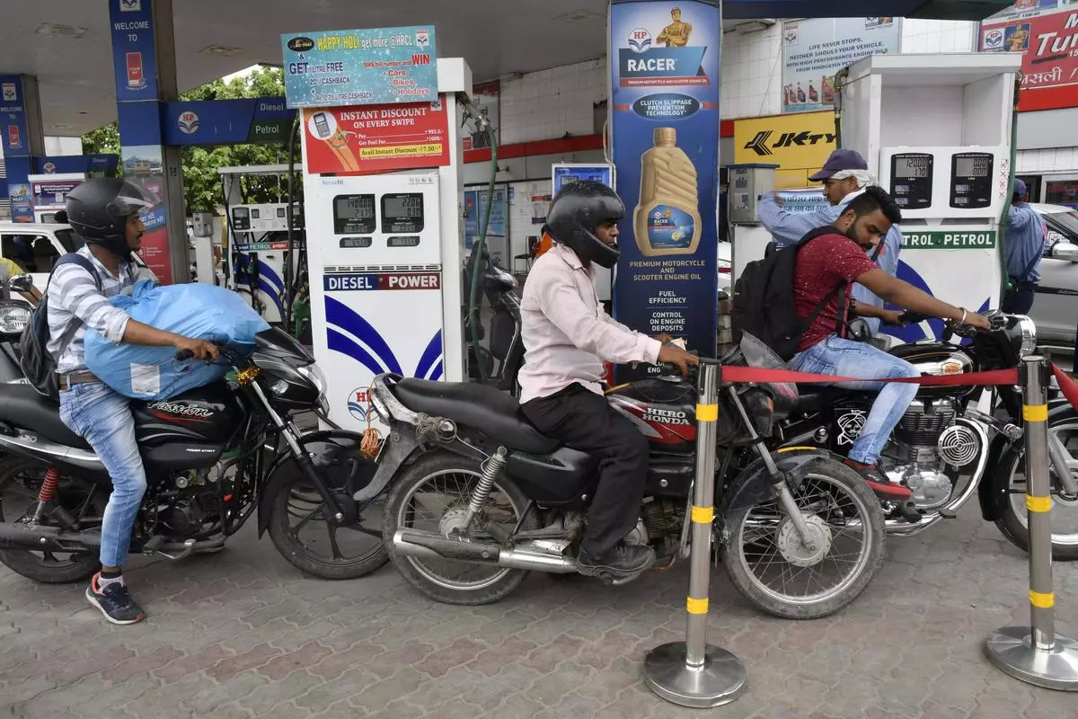 Motorists seen filling petrol in a petrol bunk