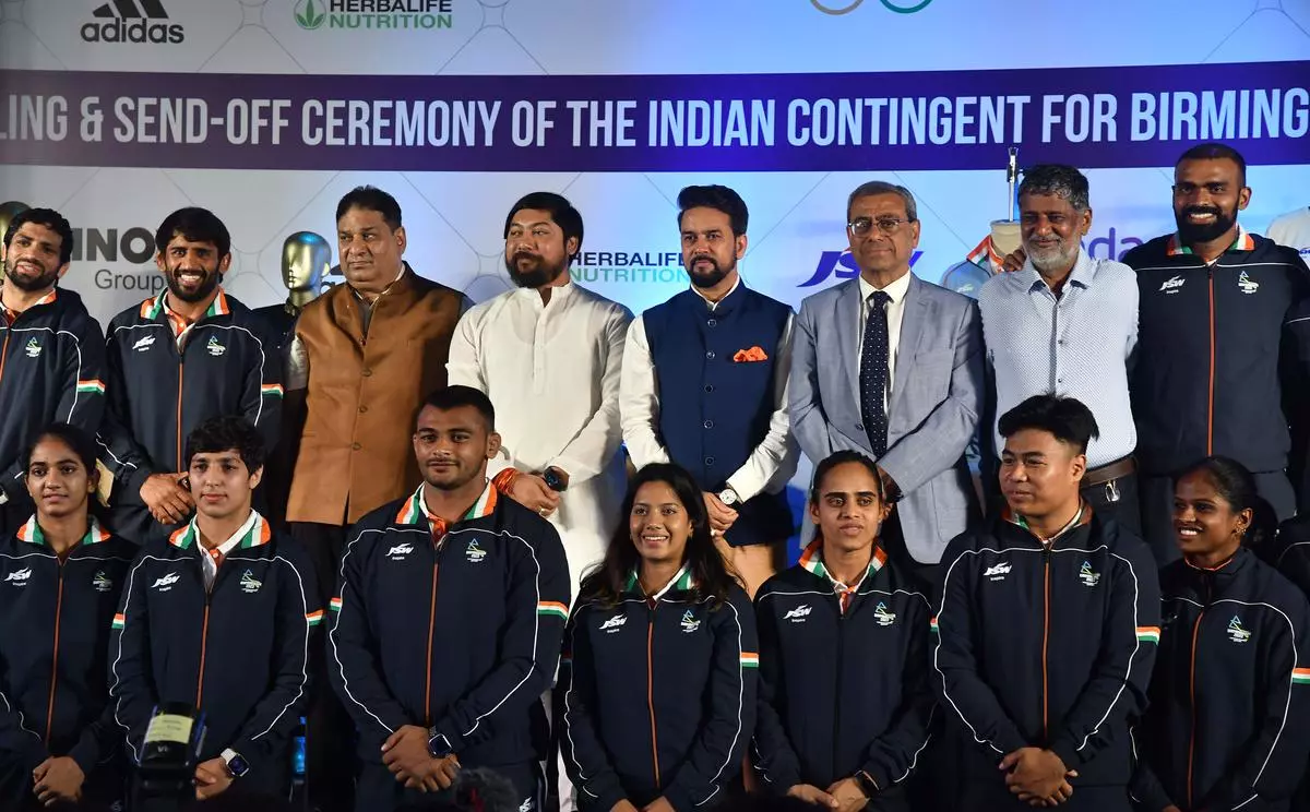 Youth Affairs and Sports Minister, Anurag Thakur with Acting president, Indian Olympic Association Anil Khanna, secretary general Olympic Association, Rajeev Mehta and sports players during the Kit unveiling and send-off ceremony of the Indian contingent for Birmingham 2022 Commonwealth Games, at Ashok Hotel in New Delhi on Thursday, July 7, 2022. ndu