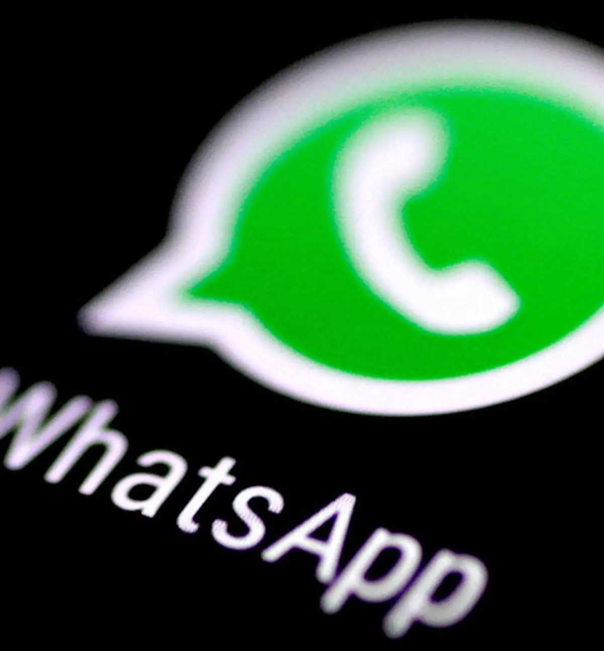 The WhatsApp logo messaging application is seen on a phone screen