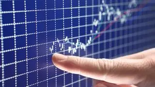 An entrepreneur points to the start of a successful business on a blue stock market graph. More Charts. istock photo for BL An entrepreneur points to the start of a successful business on a blue stock market graph. More Charts. istock photo for BL