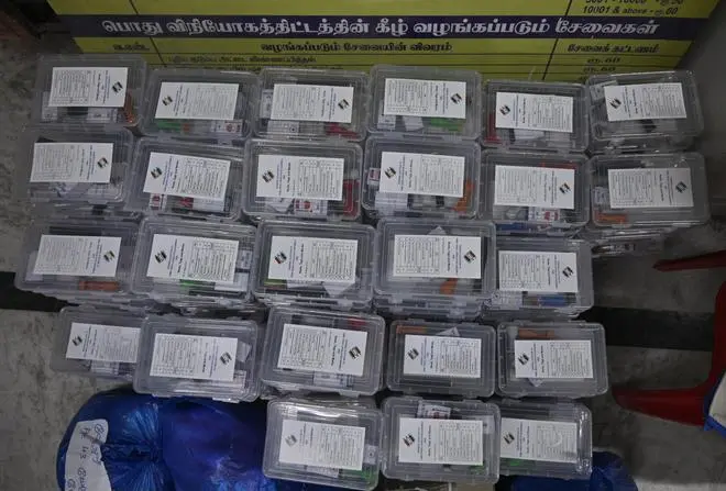 Poll materials being sorted for dispatch to the respective booths. 
Stationery items like Matchbox, sign board, pencil, blank paper, sealing wax, Gum, blade, candle stick, thread, metal ruler, carbon paper, cloth, rubber band, transparent adhesive tape, empty cup for holding indelible ink are being readied.