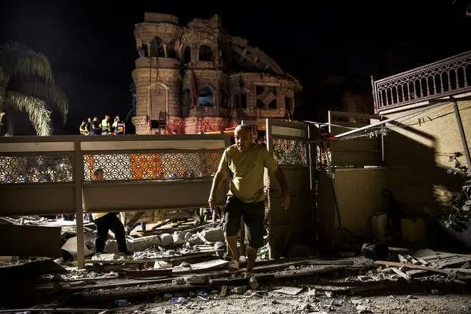 A man walks after missiles fired from Iran impacted on a residential building in northern Israel, in Tamra, Israel, June 15, 2025.