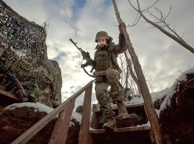 A service member of the Ukrainian armed forces walks at combat positions near the line of separation from Russian-backed rebels near Horlivka in the Donetsk region, Ukraine, January 22, 2022. A service member of the Ukrainian armed forces walks at combat positions near the line of separation from Russian-backed rebels near Horlivka in the Donetsk region, Ukraine, January 22, 2022.