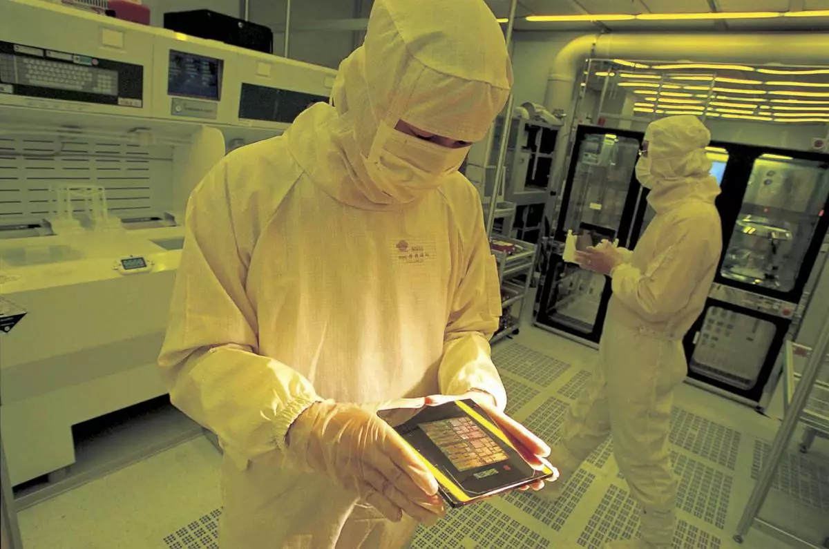 An undated handout photograph shows Taiwan Semiconductor Manufacturing Co Ltd staff working inside a semi-conductor manufacturing plant cleanroom. 