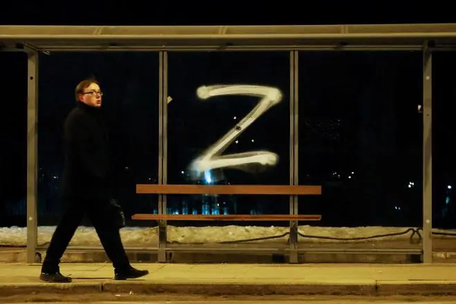 FILE PHOTO: A man walks past the symbol “Z“ painted on a bus stop in support of the Russian armed forces, as Russia‘s invasion of Ukraine continues, in Saint Petersburg, Russia March 4, 2022. FILE PHOTO: A man walks past the symbol “Z“ painted on a bus stop in support of the Russian armed forces, as Russia‘s invasion of Ukraine continues, in Saint Petersburg, Russia March 4, 2022.