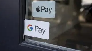 Google Pay sticker are seen at the entrance to a retail store Google Pay sticker are seen at the entrance to a retail store