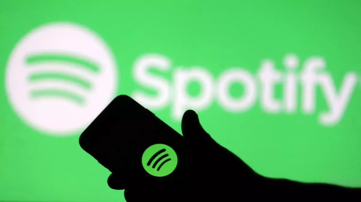 Spotify logo is seen on a phone screen 