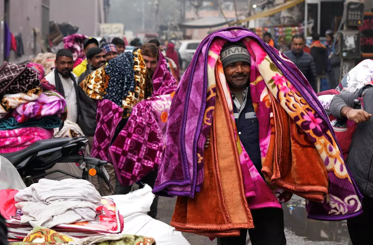 Blanket vendors at a market during a cold winter morning in New Delhi