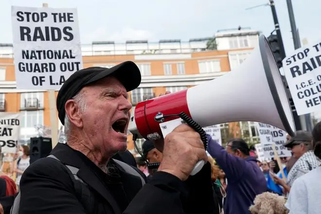 A man uses a megaphone as people take part in a demonstration as part of nationwide protests in solidarity with Los Angeles protests against federal immigration sweeps, in Washington, D.C., U.S., June 10, 2025. 