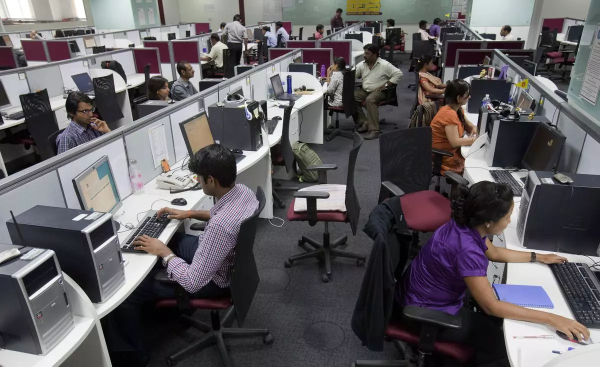 File Photo: Employees are seen at their workstations.