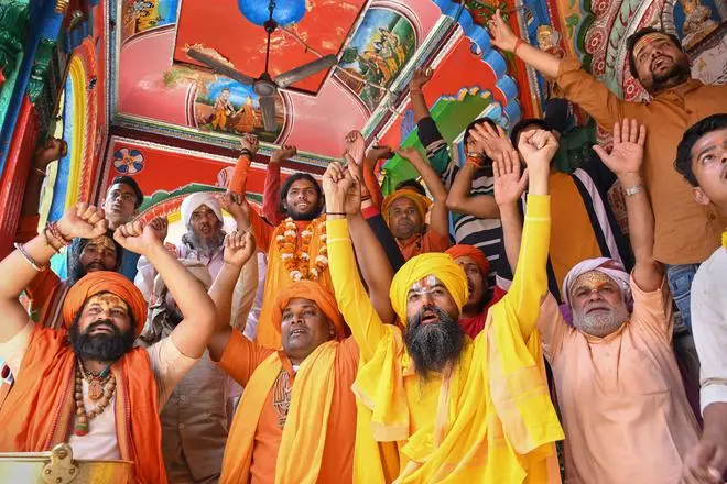 Sadhus celebrate as BJP leads, during counting day of Uttar Pradesh Assembly elections, in Ayodhya district, Thursday, March 10, 2022. - PTI Photo Sadhus celebrate as BJP leads, during counting day of Uttar Pradesh Assembly elections, in Ayodhya district, Thursday, March 10, 2022. - PTI Photo