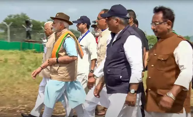 Prime Minister Narendra Modi, Madhya Pradesh CM Shivraj Singh Chouhan and others arrive to release cheetahs inside a special enclosure of the Kuno National Park in Madhya Pradesh, Saturday, Sept. 17, 2022. 