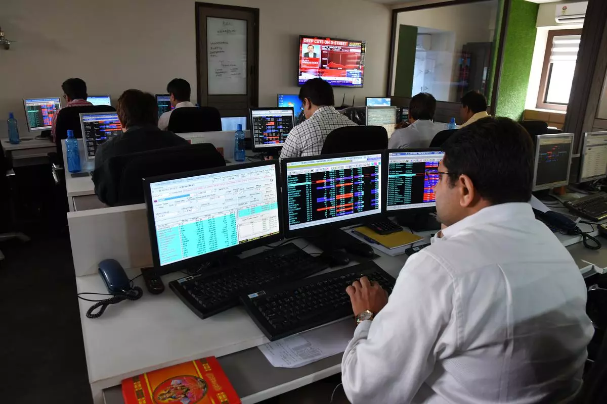 Stock trader looking at a share price on a screen at a brokerage house 
Photo: Vivek Bendre