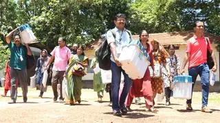 Election officials are on their way to polling stations after collecting polling materials in Meenchanda, Kozhikode, on Wednesday