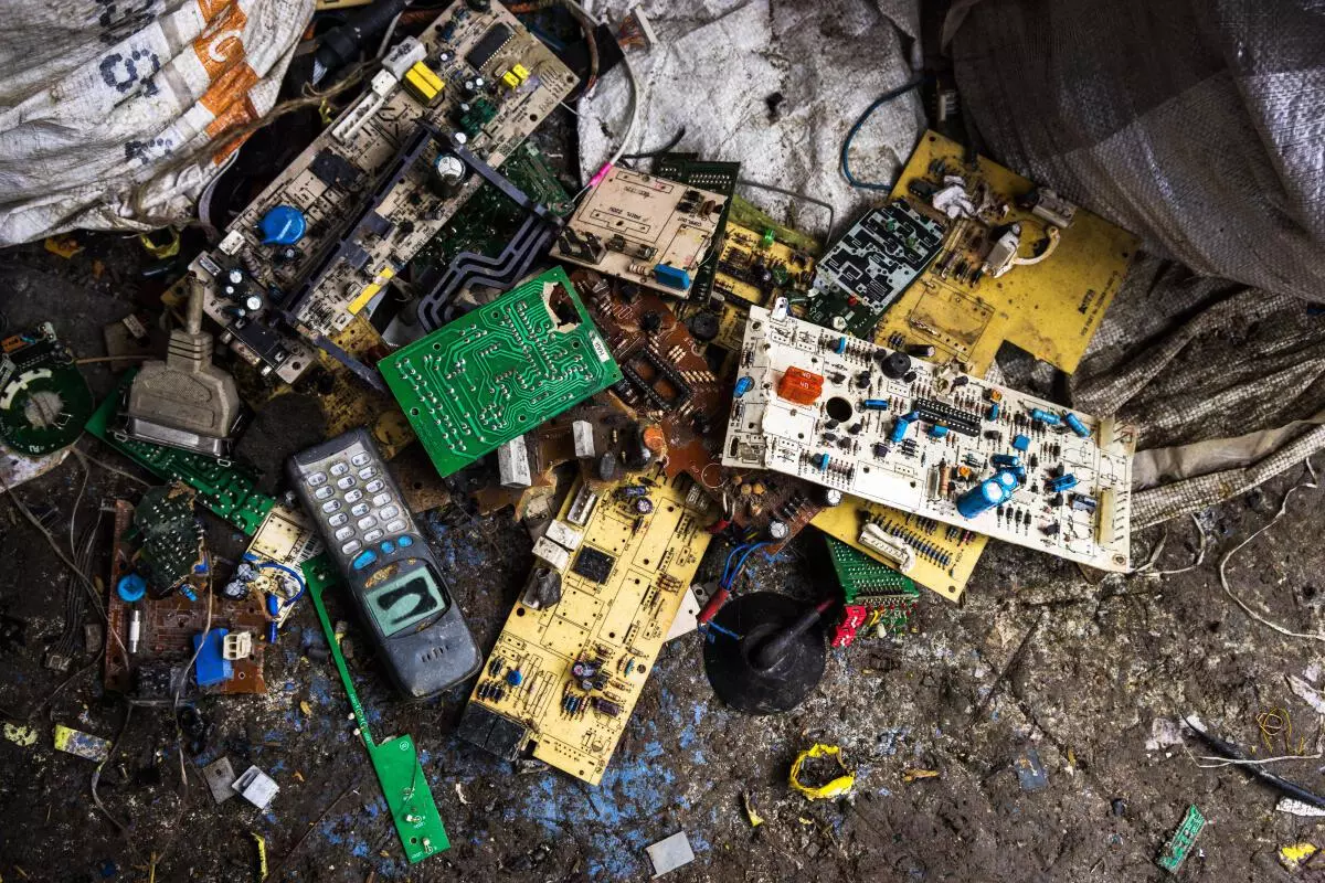 Motherboards and circuit boards sit among electronic waste strewn across the ground at a family compound of houses in Sangrampur village, West Bengal. Bloomberg/File photo
