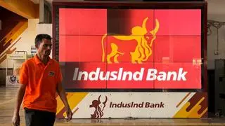 A man walks past a screen displaying the logo of IndusInd Bank at a metro station in New Delhi, India, March 25, 2025. REUTERS/Anushree Fadnavis