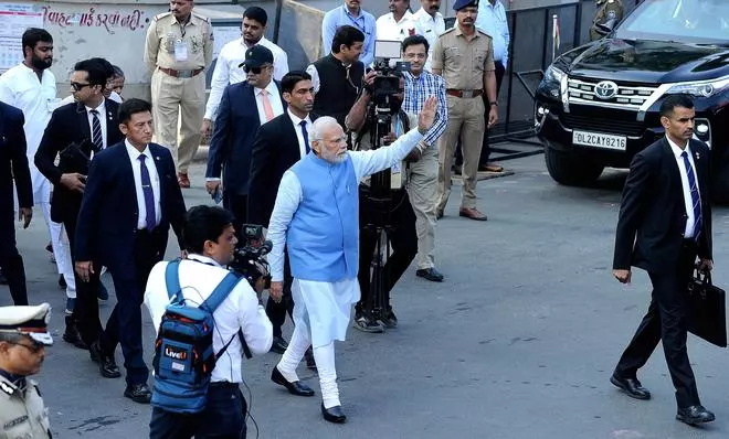 Prime Minister Narendra Modi greets the public after casting his vote in Ahmedabad on Monday, December 5, 2022.