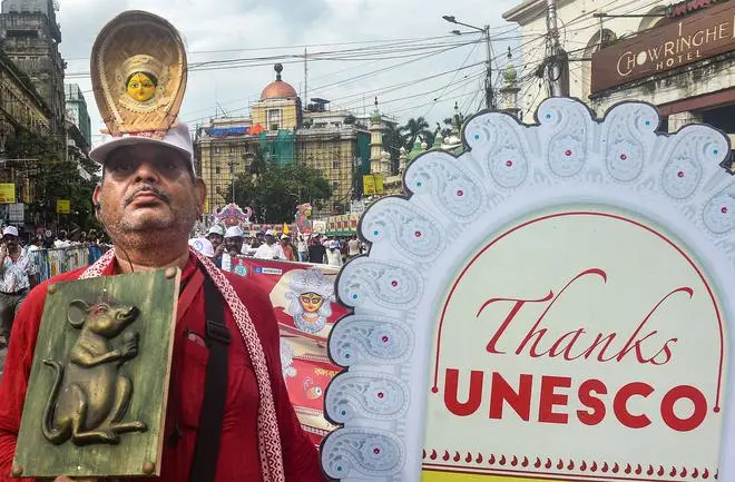 A member of a Community Durga Puja Committee participates in a rally, organised to thank UNESCO for according the Intangible Cultural Heritage (ICH) tag to Durga Puja and to launch the month-long celebrations of this year’s Durga Puja, in Kolkata, Thursday, Sept. 1, 2022. -PTI A member of a Community Durga Puja Committee participates in a rally, organised to thank UNESCO for according the Intangible Cultural Heritage (ICH) tag to Durga Puja and to launch the month-long celebrations of this year’s Durga Puja, in Kolkata, Thursday, Sept. 1, 2022. -PTI