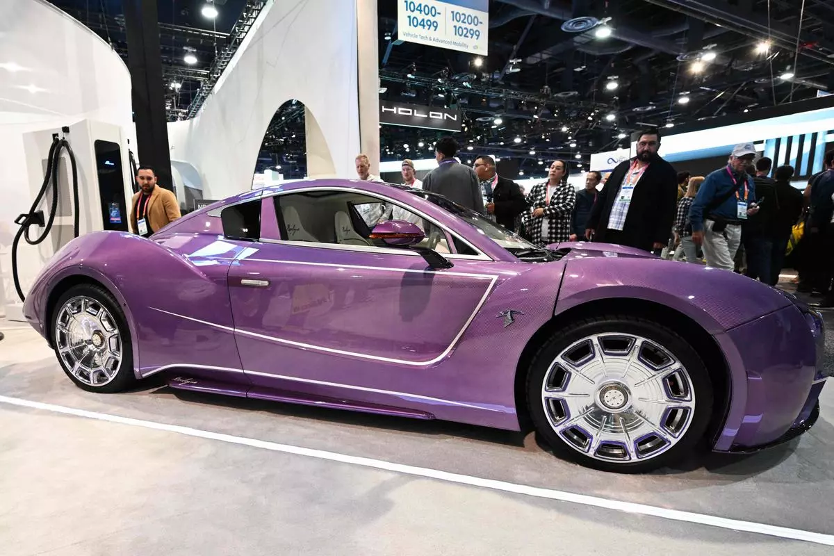 A Hispano Suiza Carmen Boulogne electric super car is displayed in front of a NB 480 electric vehicle power charging station at the Power Electronics booth during the Consumer Electronics Show (CES) in Las Vegas
