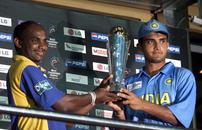 Sri Lanka’s captain Sanath Jayasuriya (L) and India’s captain Saurav Ganguly hold the ICC Champion’s trophy after the rain-marred final of the ICC Champions trophy between India and Sri Lanka in Colombo, September 30, 2002. India and Sri Lanka jointly shared the ICC Champions trophy after the final was called off due to rain. 