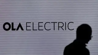 A man walks past the logo of Ola Electric during a press conference ahead of it’s IPO launch in Mumbai, India, July 29, 2024. 