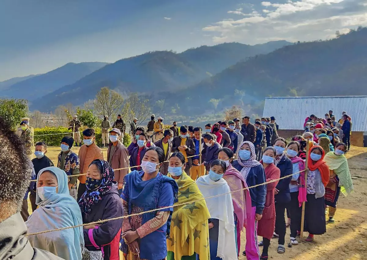 People wait to cast their votes for Assemply elections, during repolling in Senapati, Manipur, Tuesday, March 8, 2022. 