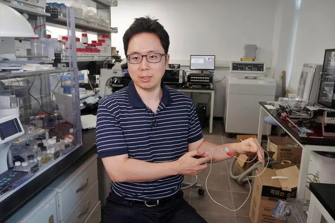 Steve Park, Materials Science & Engineering professor at Korea Advanced Institute of Science and Technology (KAIST), demonstrates an electronic tattoo (e-tattoo) on his arm connected with an electrocardiogram (ECG) monitoring system in Daejeon, South Korea, July 26, 2022. Steve Park, Materials Science & Engineering professor at Korea Advanced Institute of Science and Technology (KAIST), demonstrates an electronic tattoo (e-tattoo) on his arm connected with an electrocardiogram (ECG) monitoring system in Daejeon, South Korea, July 26, 2022.