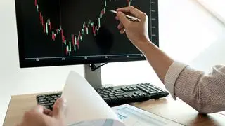 Businessman broker Examining finance recordsdata graphs and reviews on camouflage for investment functions for trading graph of stock market