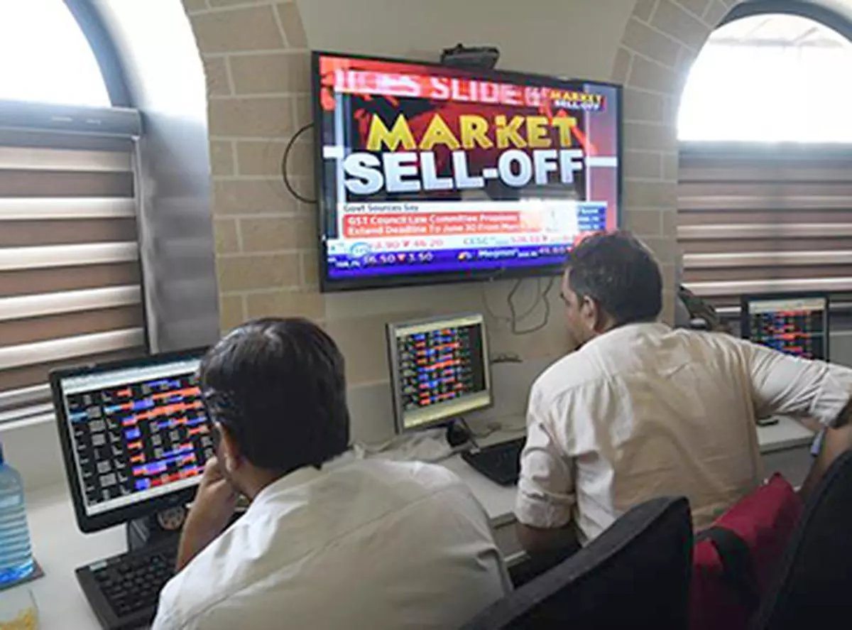 Stockbrokers watch the Bombay Stock Exchange (BSE) index on a trading terminal in Mumbai 