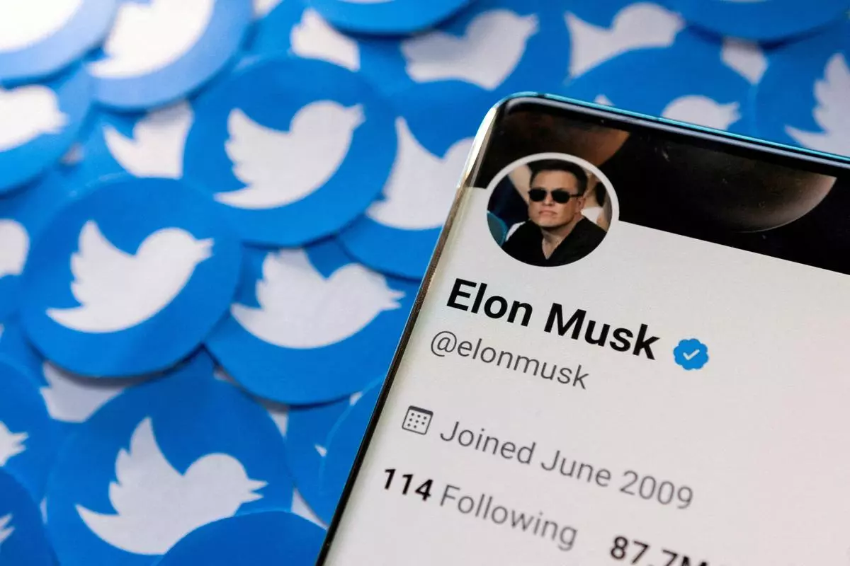 FILE PHOTO: Elon Musk’s Twitter profile is seen on a smartphone placed on printed Twitter logos.