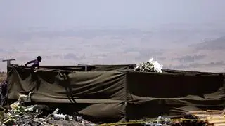 A member of a rescue team stands at the secured wreckage of the Ethiopian Airlines Flight ET 302 plane crash, near the town Bishoftu, near Addis Ababa, Ethiopia March 15, 2019