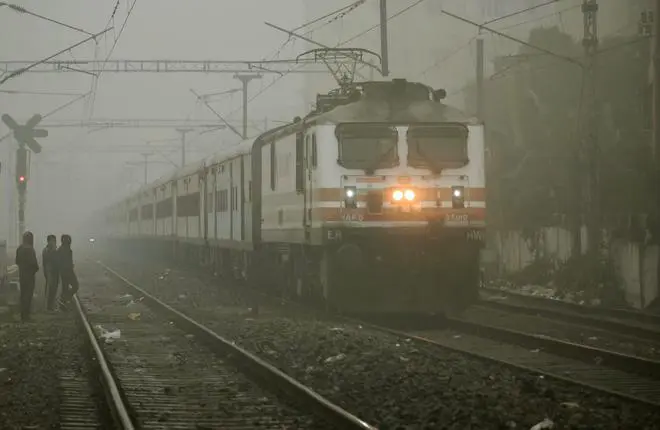 A train runs through dense fog during a cold winter morning, in Patna, Thursday, Dec. 22, 2022. A train runs through dense fog during a cold winter morning, in Patna, Thursday, Dec. 22, 2022.