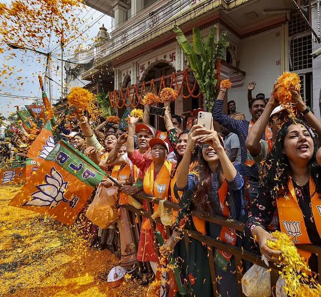 BJP supporters gather at a roadshow ahead of the Assembly elections in Bengaluru