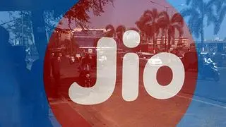 Commuters are reflected on an advertisement of Reliance Industries’ Jio telecoms unit Commuters are reflected on an advertisement of Reliance Industries’ Jio telecoms unit