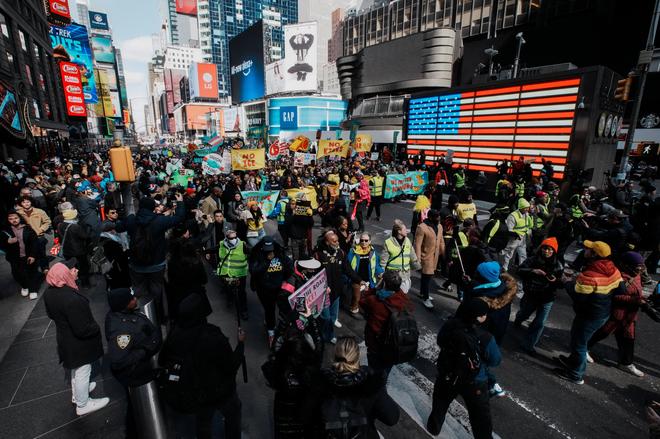 Demonstrators hold signs during a 'No Kings' protest against U.S. President Donald Trump's administration policies, in New York City, New York, U.S., March 28, 2026.