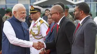 Prime Minister Narendra Modi greets delegates as he departs from Maldives.