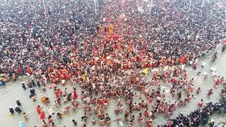 Flower petals being showered on devotees during the first ‘Amrit Snan’ at the Mahakumbh on Makar Sankranti festival, at Sangam in Prayagraj. (PTI Photo)