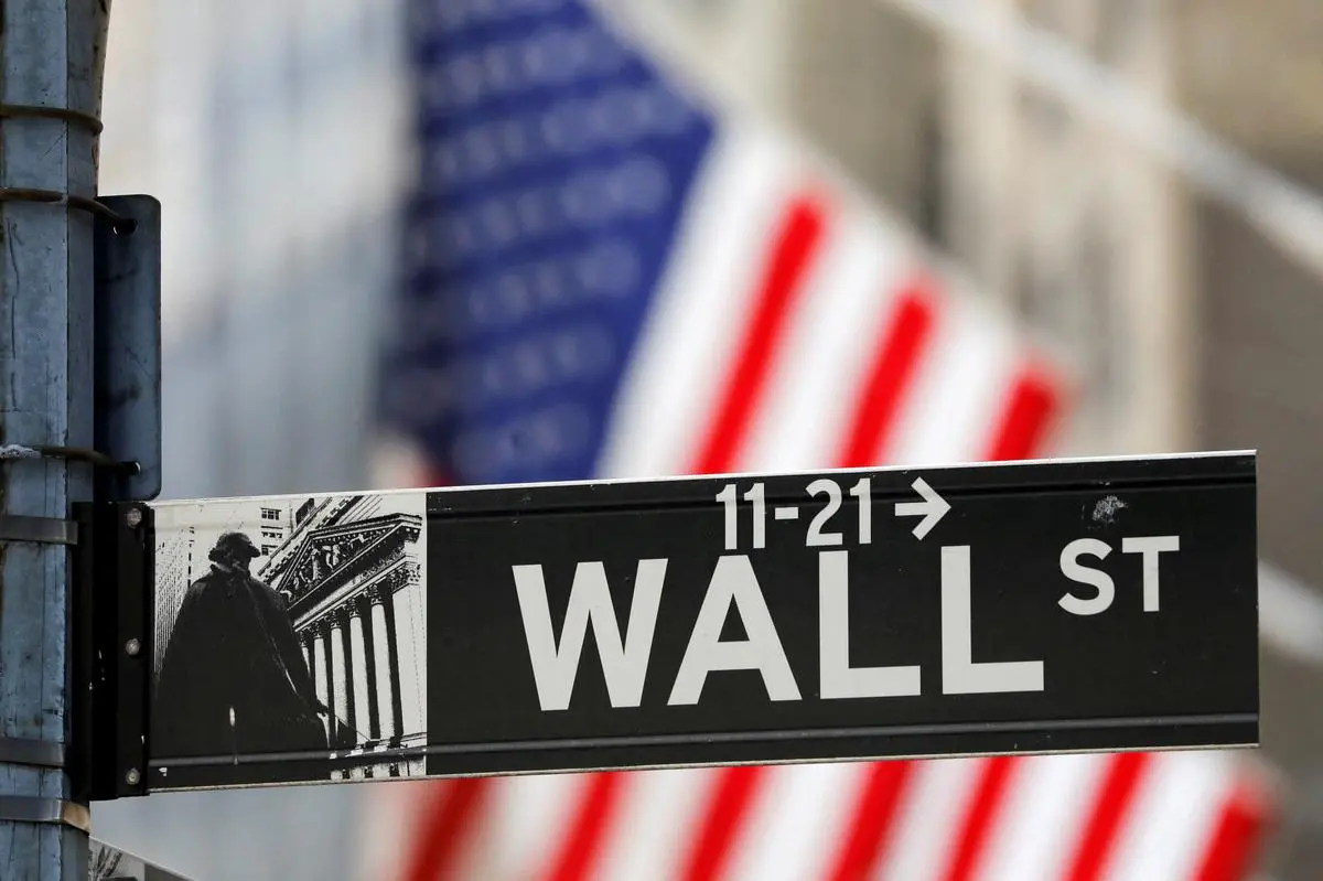 FILE PHOTO: A street sign for Wall Street is seen outside the New York Stock Exchange (NYSE) REUTERS