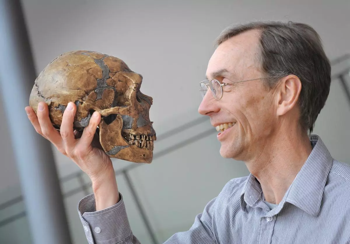 Swedish geneticist Svante Paabo, director of Leipzig’s Max Planck-Institute for Evolutionary Anthropology holds a skull in this handout picture taken in Leipzig, Germany