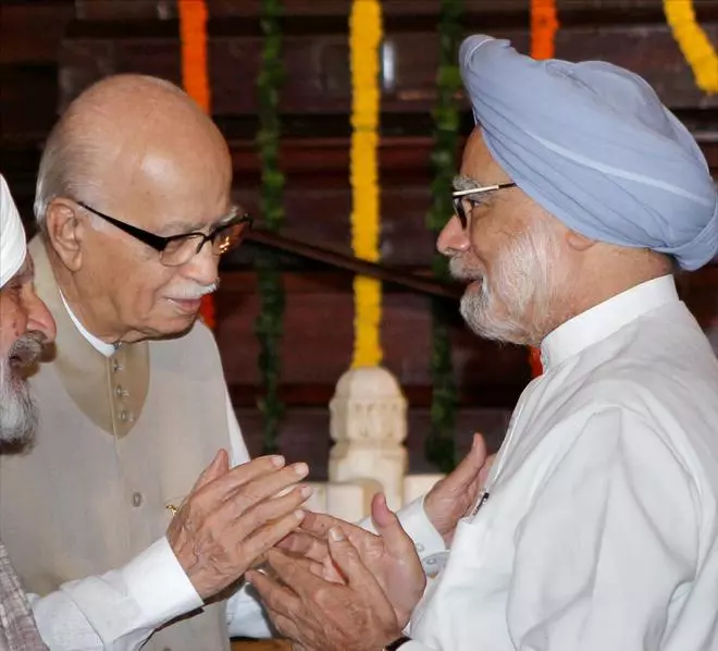 In this file image from July 23, 2013, Prime Minister Manmohan Singh is seen with senior BJP leader LK Advani after paying tributes to Lokmanya Bal Gangadhar Tilak on his birth anniversary in New Delhi.
 