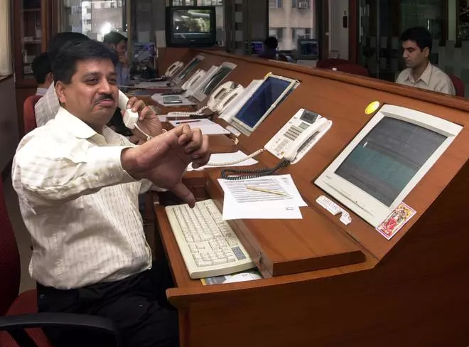 A STOCK DEALER GIVES THUMBS DOWN WHEN THE STOCK CRASHED ON BOURSES IN MUMBAI.