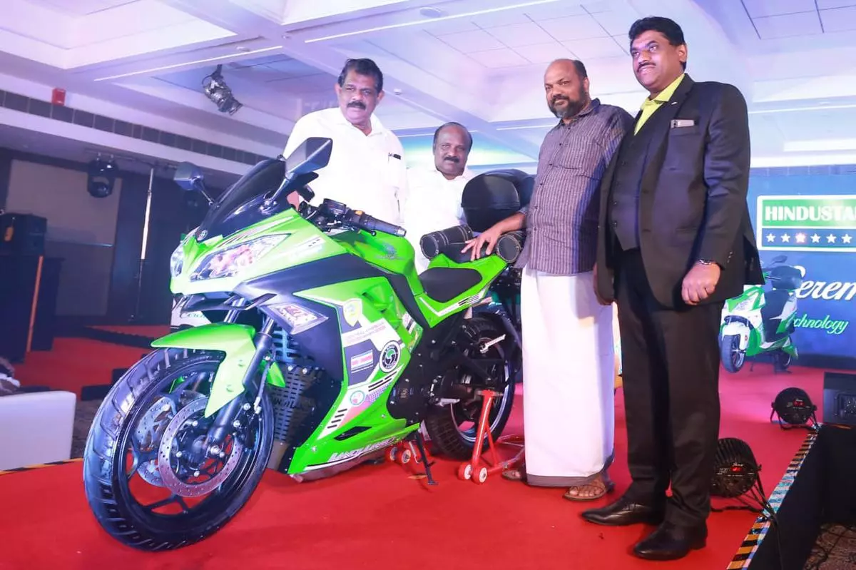 Industries Minister P. Rajeeve and Transport Minister Anthony Raju, TJ Vinod MLA and  Binju Varghese, MD, Hindustan EV Motors Corporation at the launch of electric two-wheelers in Kochi.   