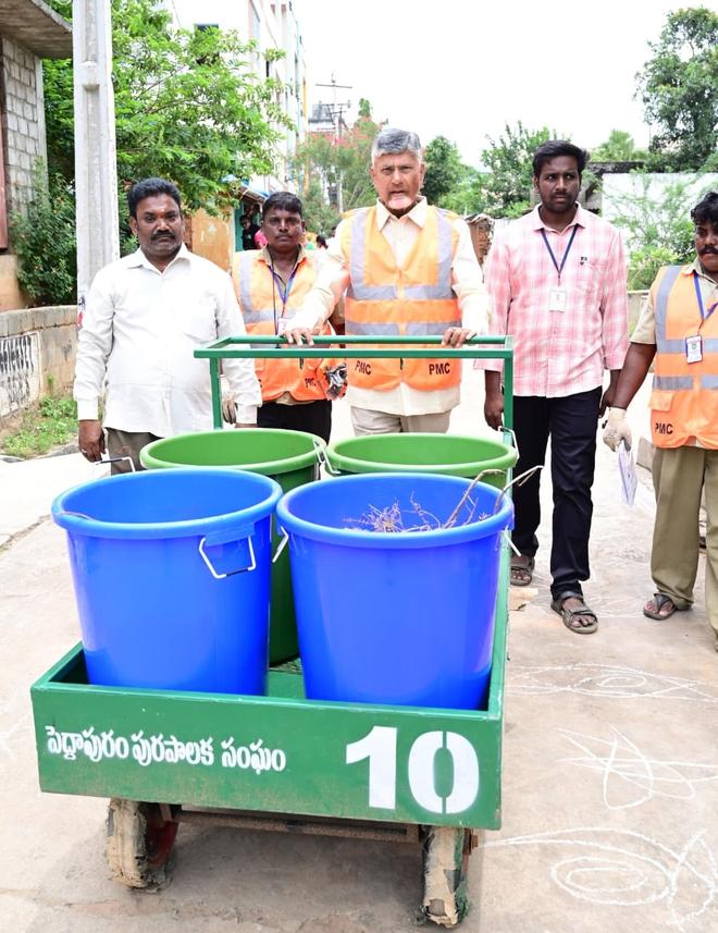 AP Chief Minister N. Chandrababu Naidu collecting solid waste from locals during the Swatch Andhra-Swarna Andhra campaign at Peddapuram in Kakinada district on Saturday. 